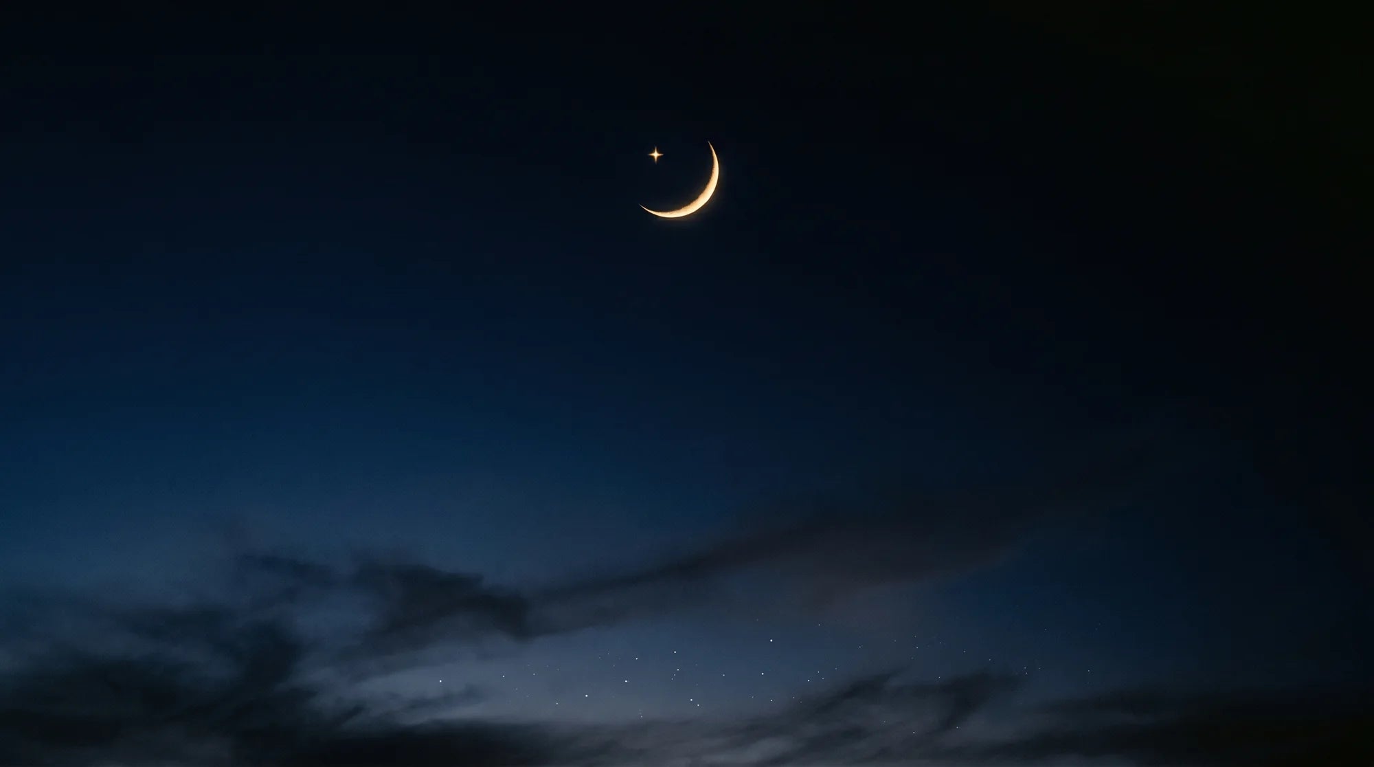 Crescent moon over a night sky